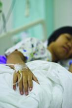 Child with IV in hospital bed